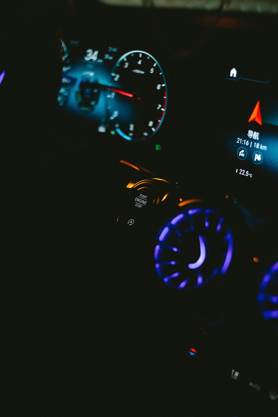 Glowing digital dashboard and center console inside a modern car.